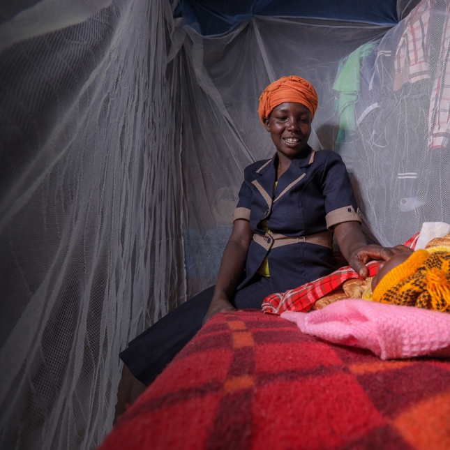 Mom and baby under mosquito net (credit: Flickr/PMI)