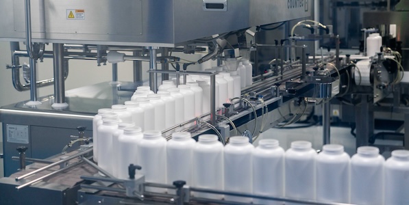 Medicine bottles moving down a production line in a manufacturing facility