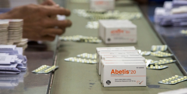 Medicines moving down a conveyor belt in a manufacturing facility