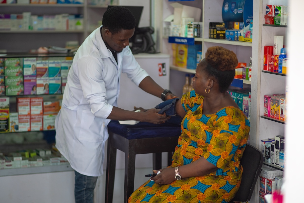 Woman in Nigeria receives care from a community pharmacy