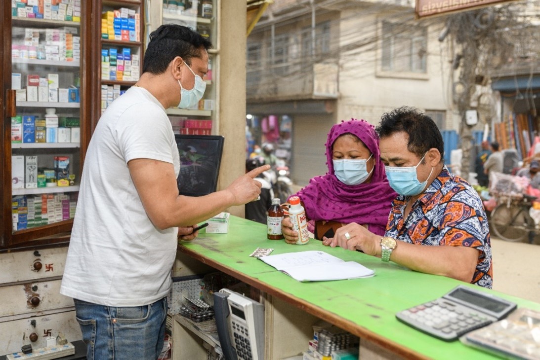 Pharmacist educates customers on quality medicines